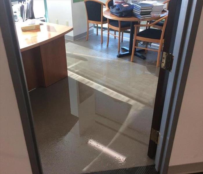 volume of water, a large spill, on a carpet in an office area