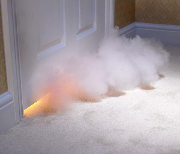 Smoke entering room from under door; flames seen under door