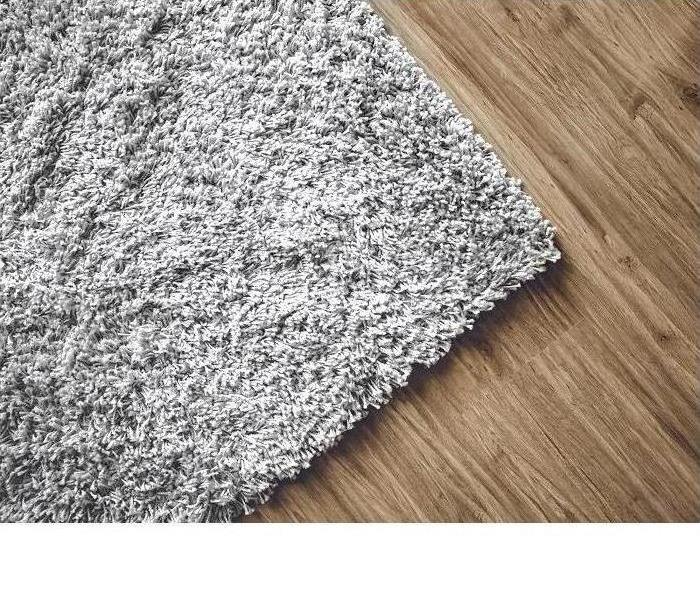 corner of carpet on hardwood floor