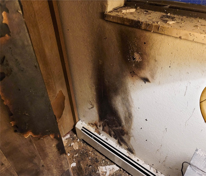 a fire damaged wall under a window