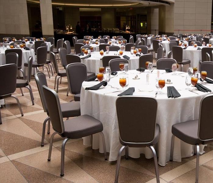 tables and chairs set for meal in large event venue