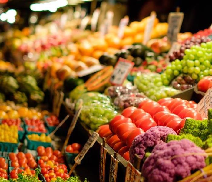 A colorful display of fresh produce is showcased in the grocery store's produce section. There is a variety of produce